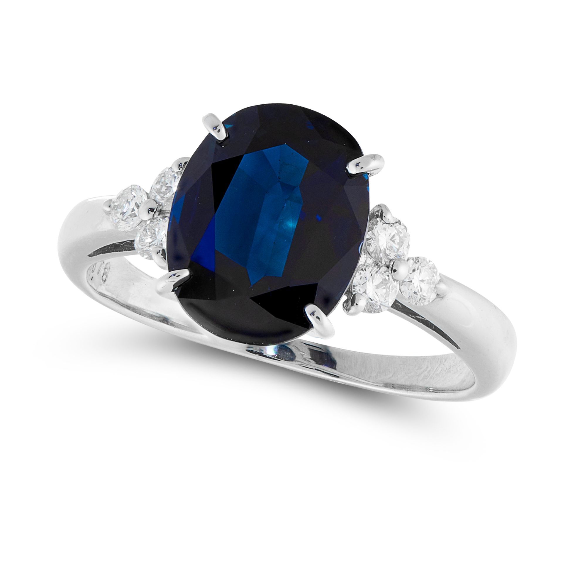 A SAPPHIRE AND DIAMOND RING in platinum, set with an oval cut sapphire of 2.78 carats between a trio