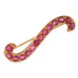 AN ANTIQUE BURMA NO HEAT RUBY BROOCH in yellow gold, in the form of an S shaped scroll, set with