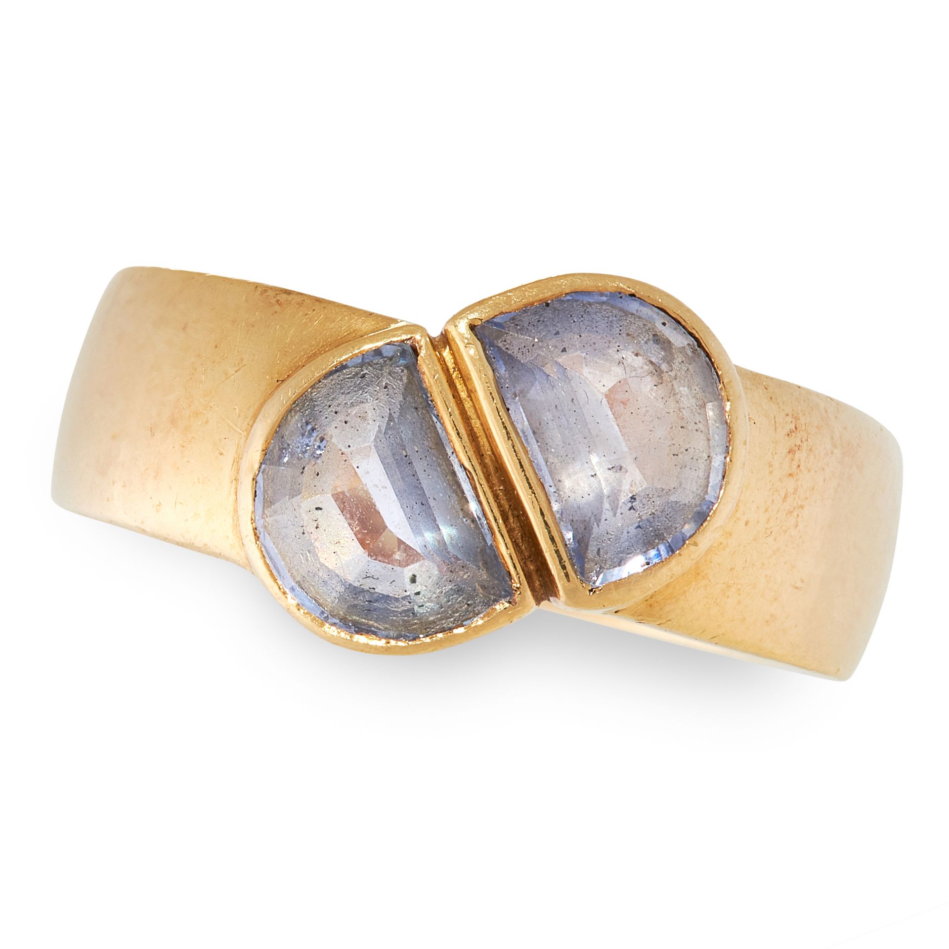 A GEMSET RING, MANFREDI in 18ct yellow gold, the thick band is set with two fancy cut blue