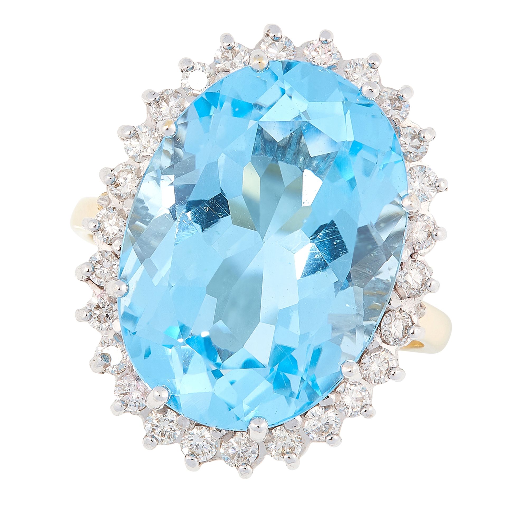 A TOPAZ AND DIAMOND CLUSTER RING in 18ct yellow gold, set with an oval cut topaz in a border of