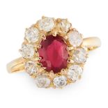 A RUBY AND DIAMOND CLUSTER RING in yellow gold, set with an oval cut ruby of 0.79 carats in a border