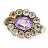AN AMETHYST AND PASTE DRESS RING set with an oval cut amethyst within a border of old European cut