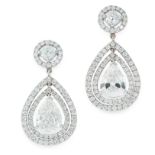 A PAIR OF DIAMOND EARRINGS in platinum, each set with a pear cut diamond of 1.01 and 1.01 carats,