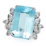 A TOPAZ AND DIAMOND RING in white gold, set with an emerald cut emerald of 13.66 carats between