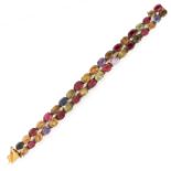 A VINTAGE GEMSET BRACELET in yellow gold, comprising two rows of graduated oval cut gemstones