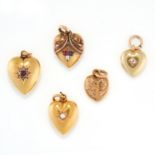 A SET OF FIVE ANTIQUE HEART LOCKET CHARM PENDANTS in yellow gold, one jewelled with a pearl, one