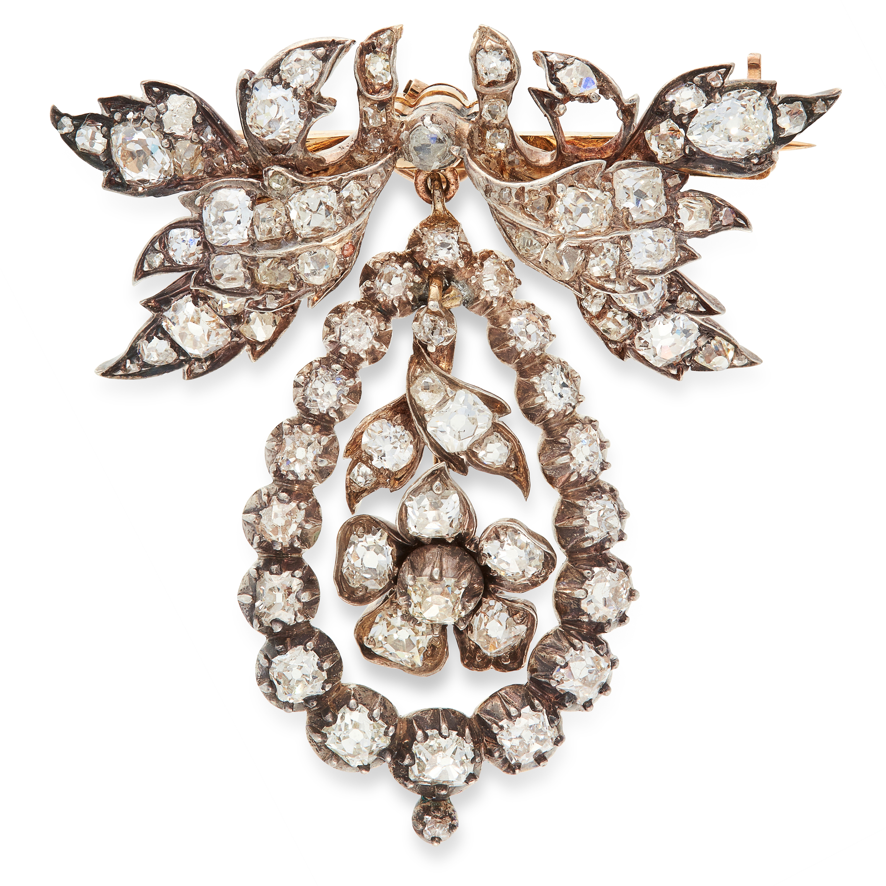 AN ANTIQUE DIAMOND PENDANT / BROOCH in yellow gold and silver, in foliate design, set with old cut