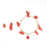 A CORAL CHARM BRACELET the oval link bracelet set with carved pig, rabbit, dog and turtle charms,