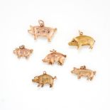 A SET OF SIX GOLD PIG CHARMS some stamped 9ct, the charms range from 25mm - 17mm, total weight: 7.