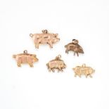 A SET OF FIVE GOLD PIG CHARMS in yellow gold, four are stamped 9ct, the charms range from 25mm -