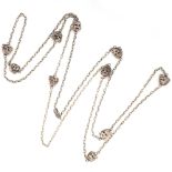 AN ANTIQUE GUARD CHAIN NECKLACE in silver, set with ten staggered faces charms, unmarked, 77cm, 40.