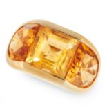 A VINTAGE CITRINE RING in yellow gold, set with a central step cut citrine between two fancy cut