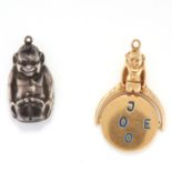 A SET OF TWO GOBLIN CHARMS comprising of a goblin charm and a spinning charm which spells 'I love