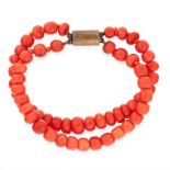 A TWO ROW CORAL BEAD BRACELET comprising of two rows of polished coral beads, unmarked, 17cm, 24.