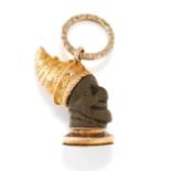 AN ANTIQUE CARVED LAVA PENDANT in yellow gold, designed as a bust carved from volcanic lava, in an