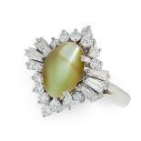 A CHRYSOBERYL CAT'S EYE AND DIAMOND CLUSTER RING in platinum, set with a cabochon chrysoberyl cat'