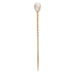 A SET OF THREE NATURAL SALTWATER PEARL STICK PINS in yellow gold, one set with a grey pearl 8.