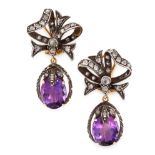 A PAIR OF AMETHYST AND DIAMOND EARRINGS in 18ct yellow gold and silver, in the form of a ribbon