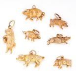 A SET OF SEVEN GOLD PIG CHARMS in yellow gold, one stamped 18ct, the charms range from 25mm -