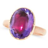 AN AMETHYST DRESS RING in yellow gold, set with an oval cut amethyst in a gold border, unmarked,