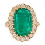 A COLOMBIAN EMERALD AND DIAMOND CLUSTER RING in yellow gold, set with a mixed cushion cut emerald of