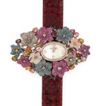 A GEMSET FLOWER WATCH, MONTRE USA in silver, set with a mother of pearl face within an oval border