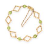 A PERIDOT AND PEARL BRACELET, EARLY 20TH CENTURY in yellow gold, formed of diamond shaped links