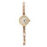 A VINTAGE LADIES WRIST WATCH in yellow gold and silver, with cream dial, on expandable bracelet, the