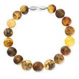 AN AMBER BEAD NECKLACE in silver, set with seventeen round, polished amber beads, unmarked, 51cm,