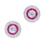 A PAIR OF DIAMOND AND RUBY STUD EARRINGS in 18ct white gold, of target design, the circular body