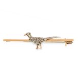 AN ANTIQUE DIAMOND PHEASANT BROOCH, CIRCA 1910 in yellow gold and silver, the plain bar with applied