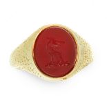 A HARDSTONE INTAGLIO SEAL SIGNET RING in yellow gold, the face set with an oval piece of