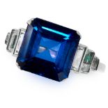 A SYNTHETIC SAPPHIRE DRESS RING set with a step cut synthetic sapphire between baguette white