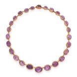 AN AMETHYST RIVIERE NECKLACE comprising a single row of twenty-six graduated oval cut amethyst in