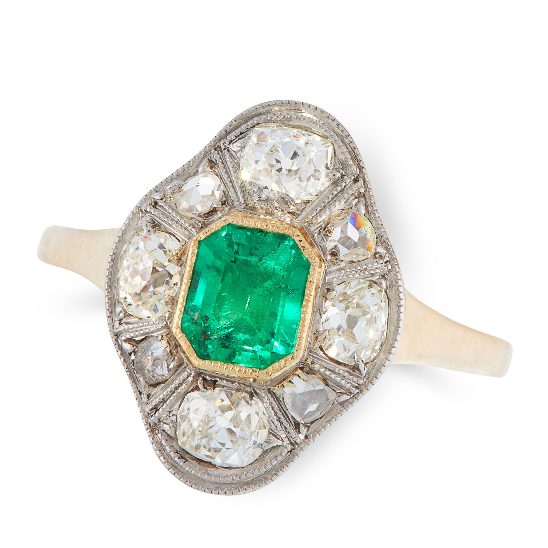 A COLOMNBIAN EMERALD AND DIAMOND DRESS RING, CIRCA 1940 in 14ct yellow gold, the navette shaped face