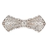 AN ANTIQUE DIAMOND BROOCH, CIRCA 1900 in yellow gold and silver, designed as a bow, set with a