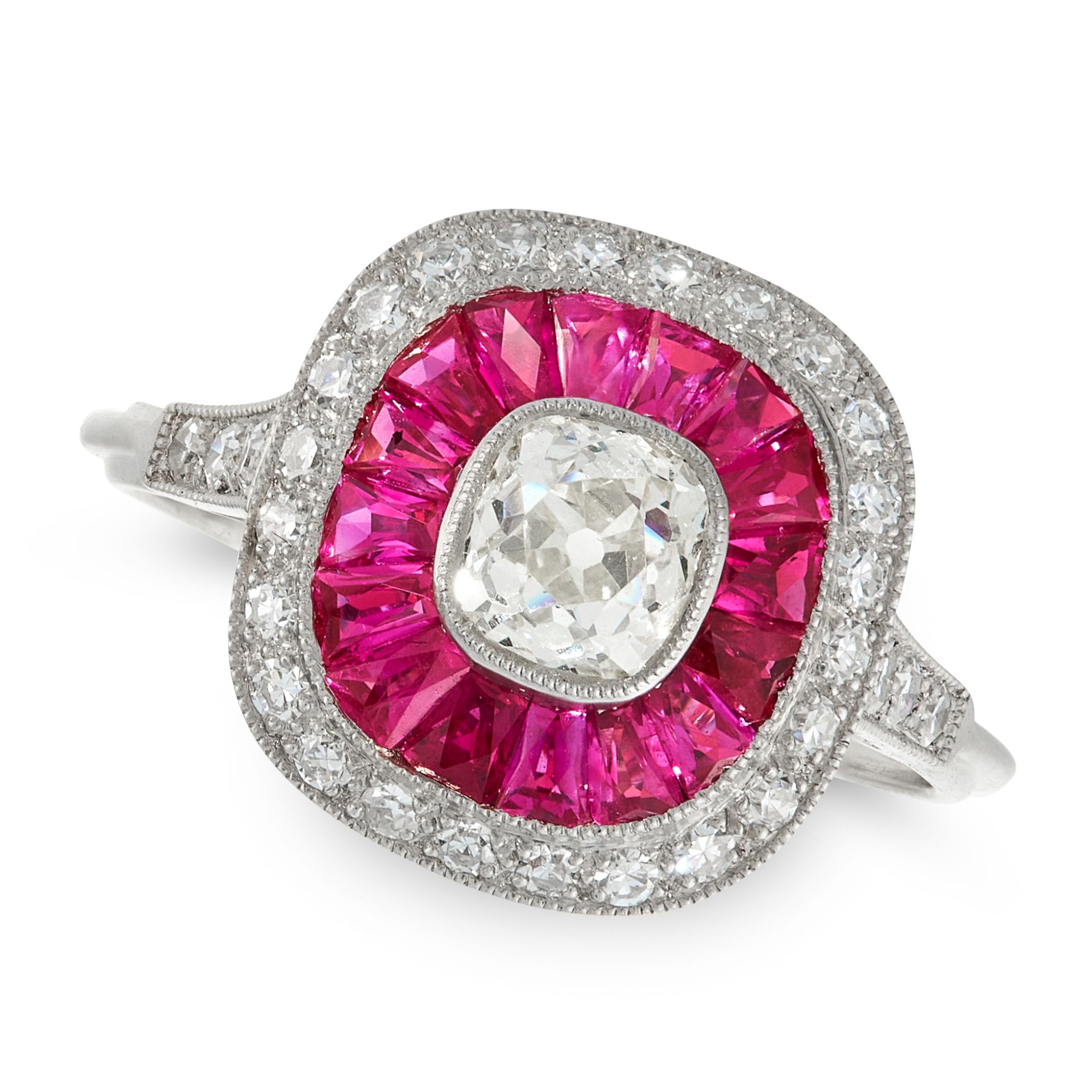 A DIAMOND AND RUBY DRESS RING in platinum, of target design, set with an old cut diamond of 0.58