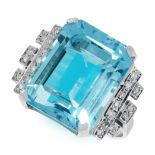 A TOPAZ AND DIAMOND DRESS RING in 18ct yellow gold, set with an emerald cut blue topaz of 16.43
