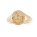 AN ENGRAVED SEAL SIGNET RING, 1926 in 18ct yellow gold, the oval face reverse engraved to depict