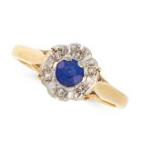 A SAPPHIRE AND DIAMOND CLUSTER RING in 18ct yellow gold, set with a round cut sapphire in a border