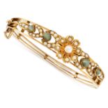 AN ANTIQYE CHRYSOBERYL AND PEARL BANGLE, LATE 19TH CENTURY in yellow gold, the tapering body with