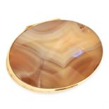 A HARDSTONE SNUFF BOX mounted in yellow metal, the lid and base with inset polished oval pieces of