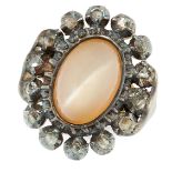 AN ANTIQUE MOONSTONE AND DIAMOND CLUSTER RING in yellow gold and silver, comprising of a cabochon