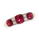 A RUBY AND DIAMOND DRESS RING in high carat yellow gold, set with a trio of graduated cushion cut