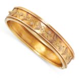 AN ANTIQUE BANGLE, CIRCA 1900 in yellow gold, the body engraved with foliate designs and with