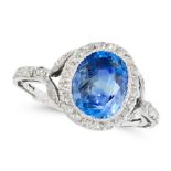 A CEYLON NO HEAT SAPPHIRE AND DIAMOND DRESS RING set with a cushion cut blue sapphire of 4.18 carats