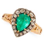 AN ANTIQUE COLOMBIAN EMERALD AND DIAMOND RING in yellow gold and silver, set with a pear cut emerald