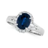 A SAPPHIRE AND DIAMOND CLUSTER RING in platinum, set with an oval cut sapphire of 1.42 carats in a