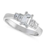 A DIAMOND DRESS RING in platinum, set with a central emerald cut diamond of 0.71 carats, between