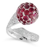 A RUBY AND DIAMOND DRESS RING in 18ct white gold, in cross over open band design, set with a sphere,